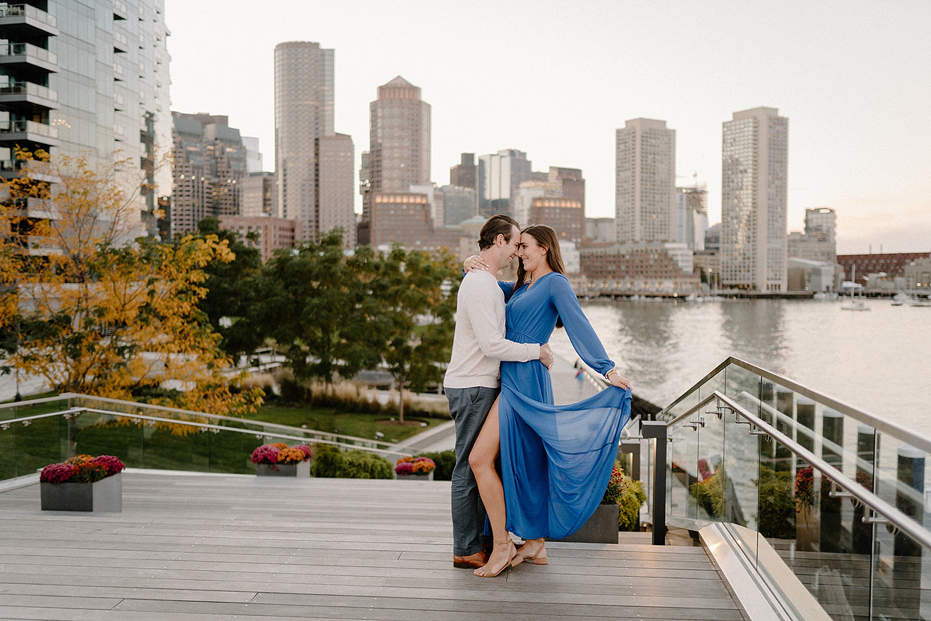 woman in blue flowy dress with fiancé  during engagement session