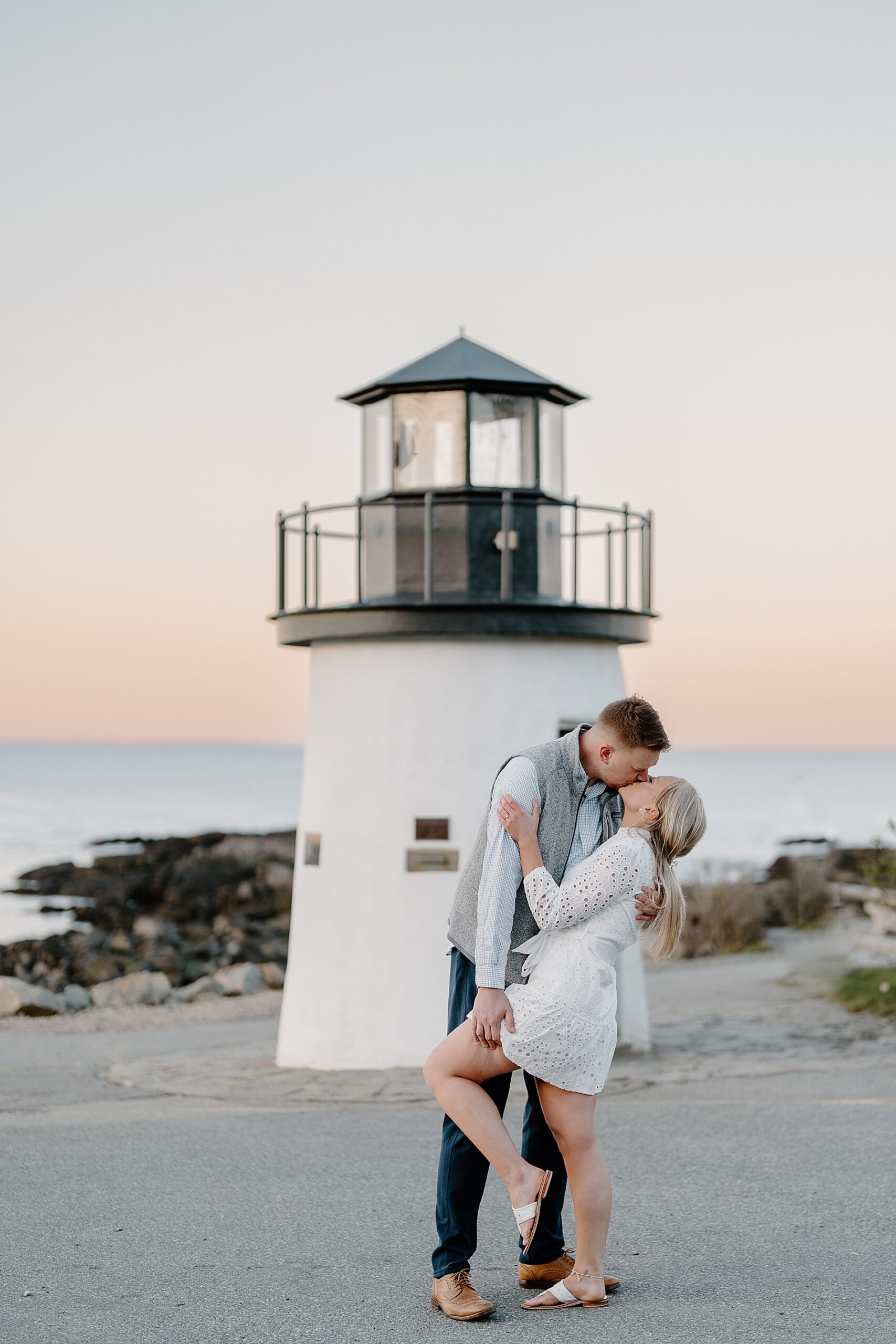 Romantic beach engagement by lighthouse