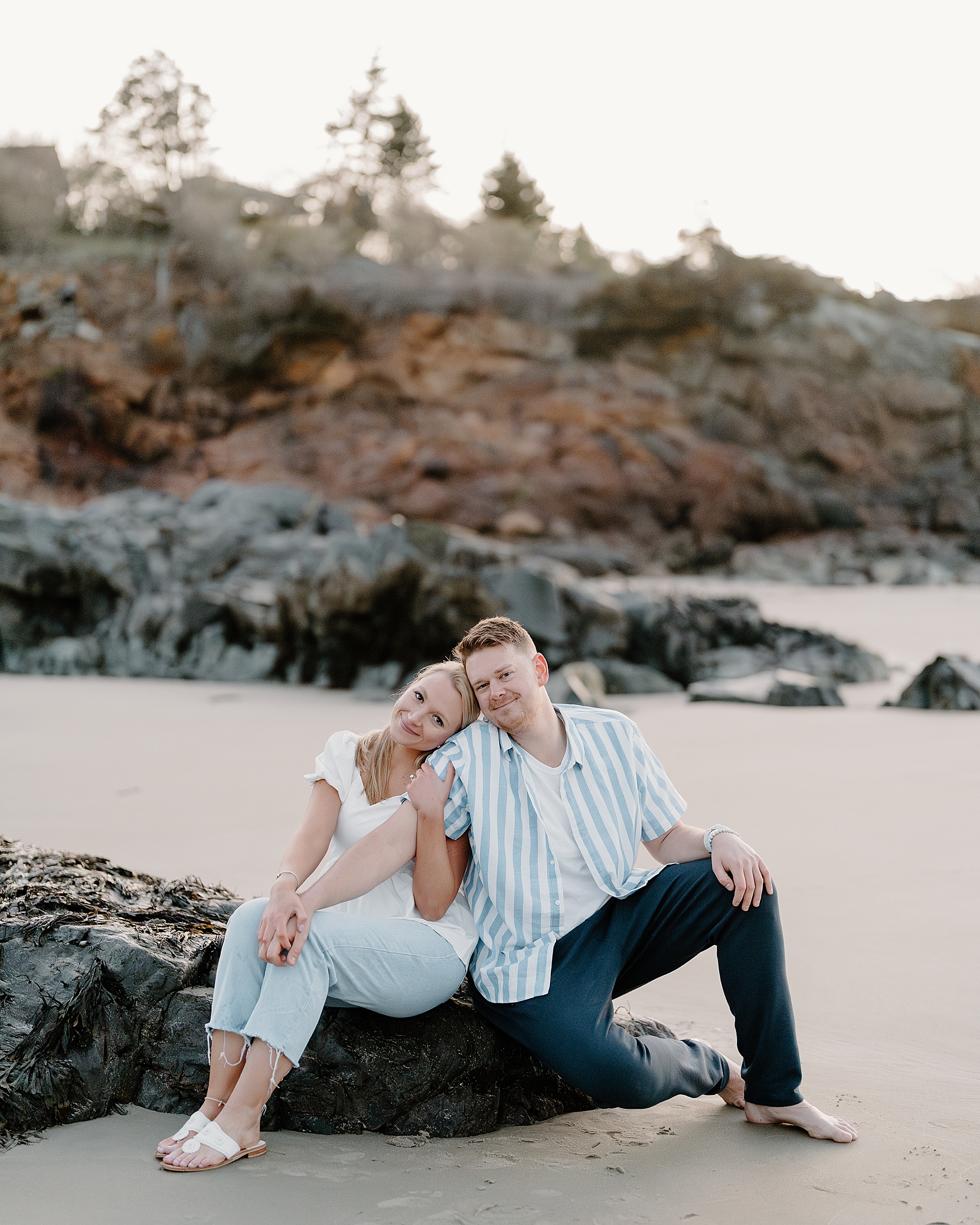 couple set on the beach during engagement session 