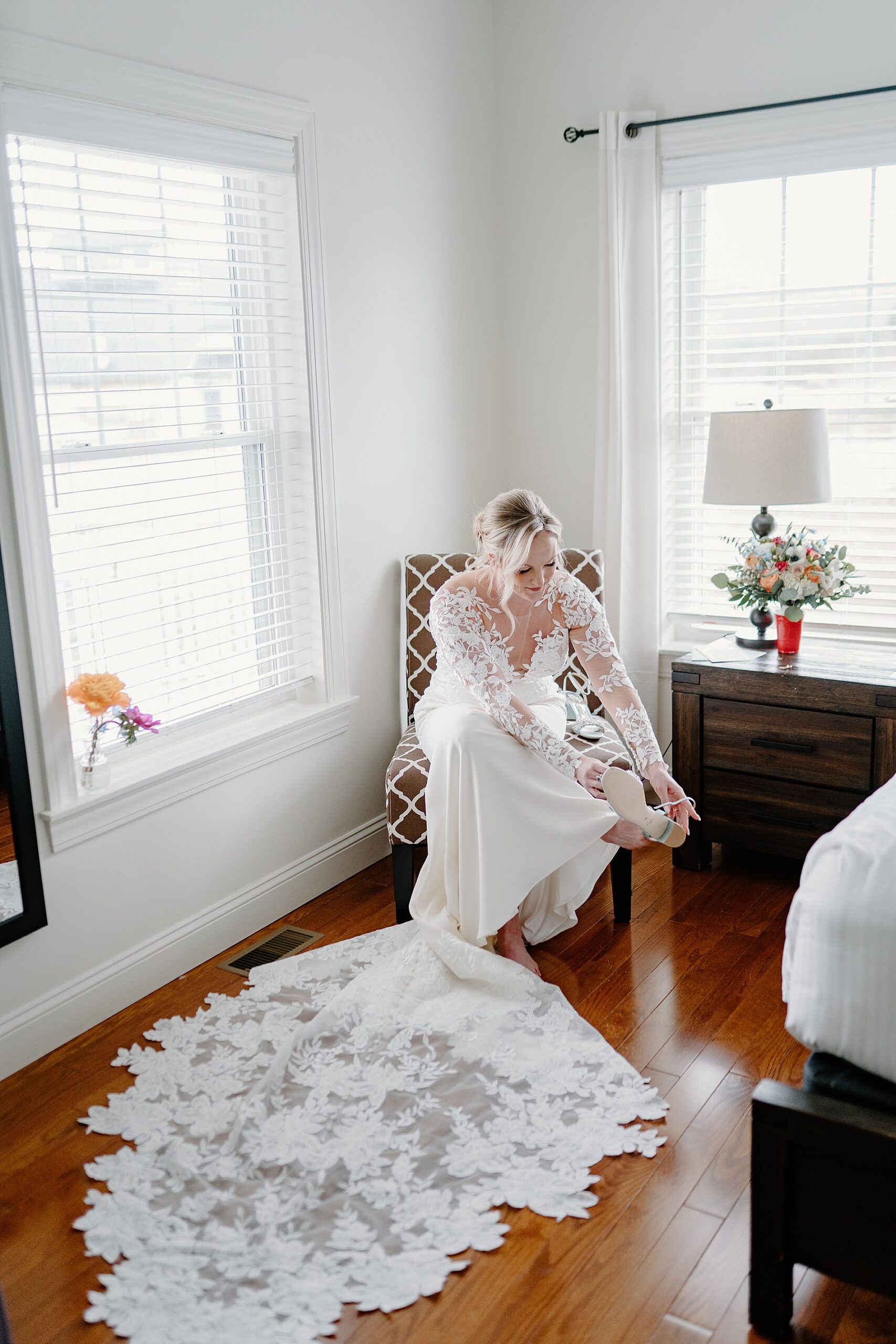 bride putting on wedding shoes