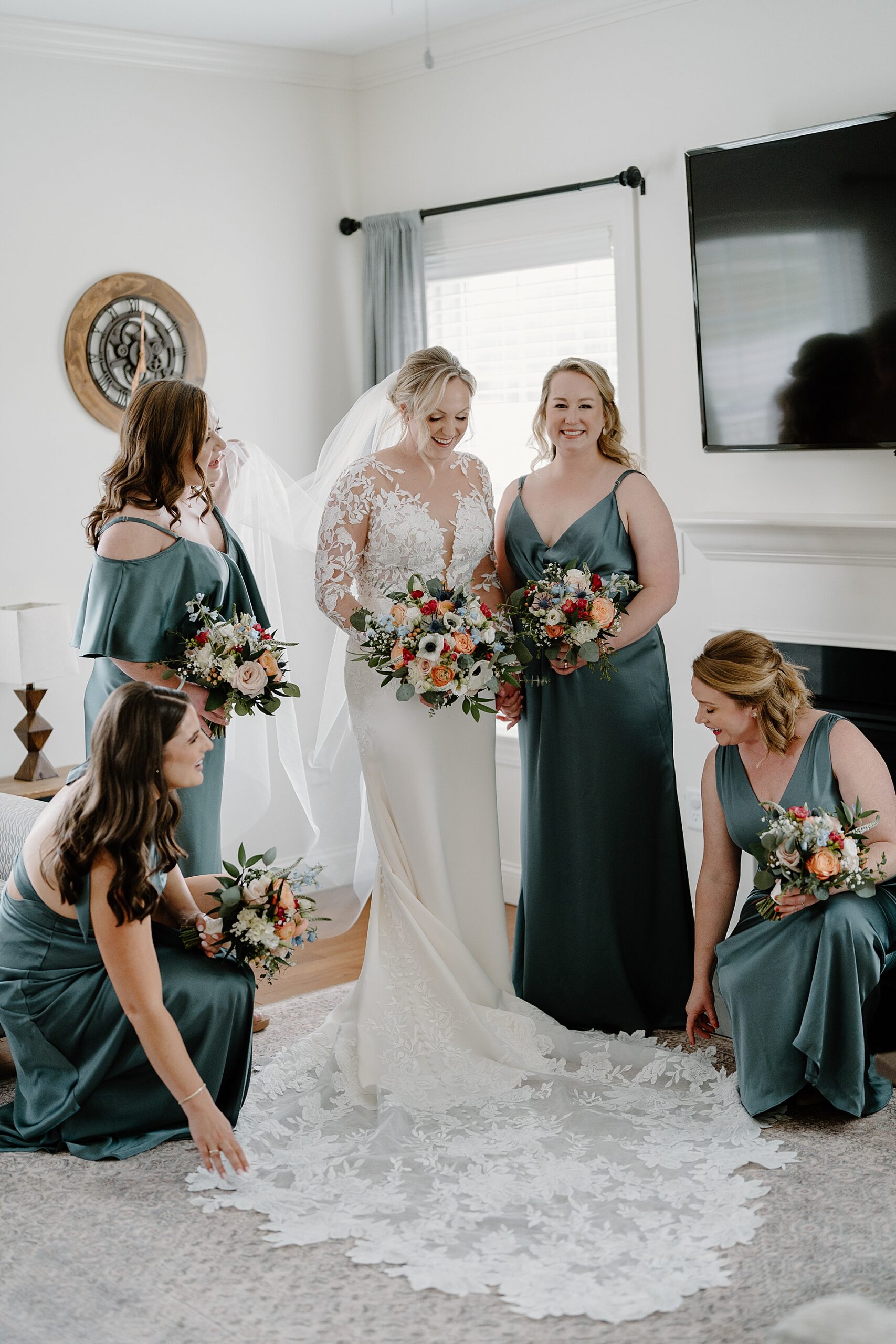 bridesmaids fan out bride's wedding dress