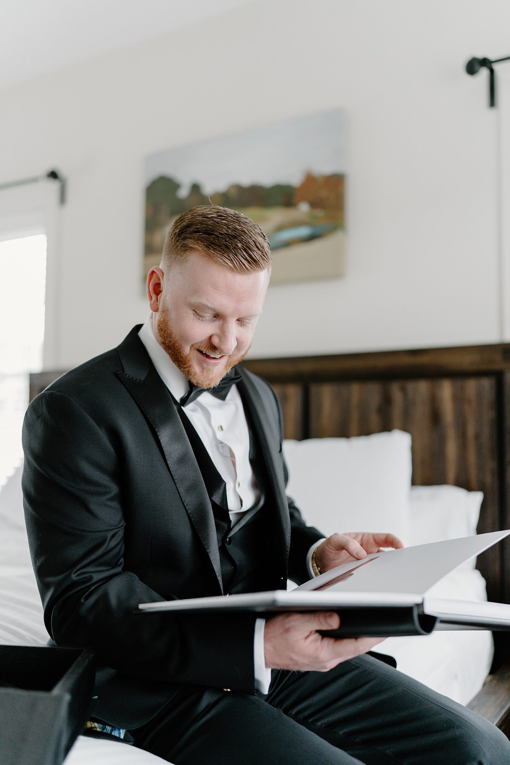 groom opens wedding gift