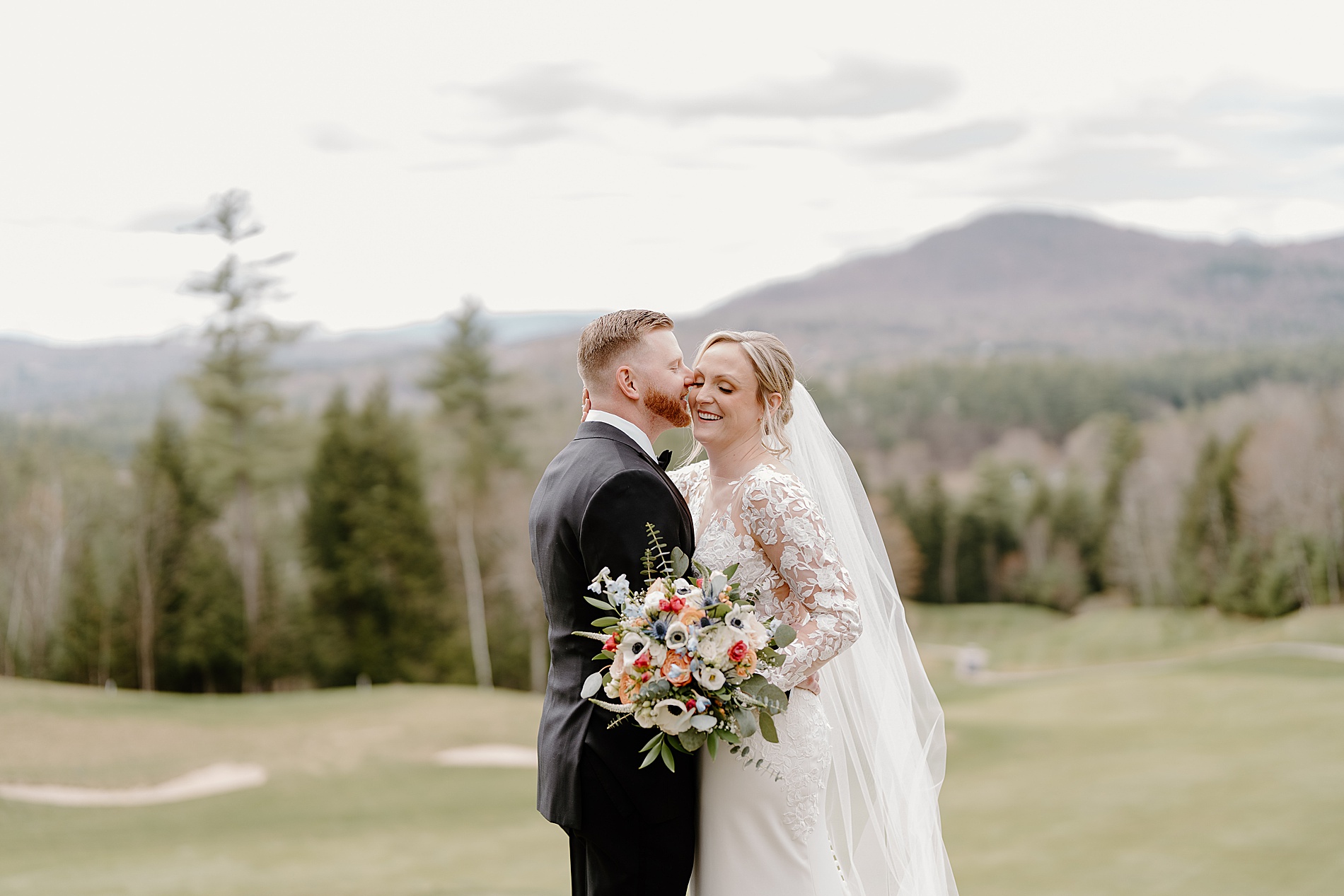groom kisses bride's cheek 