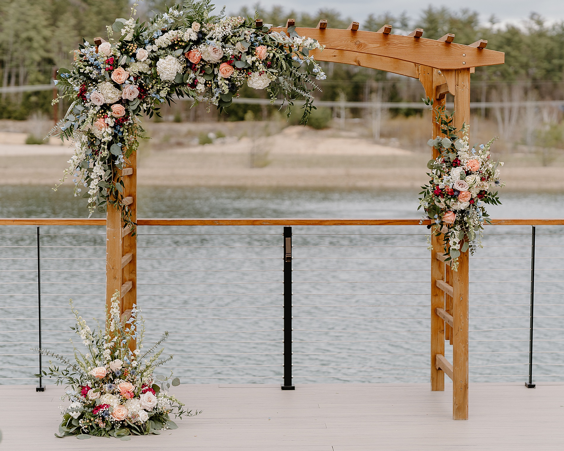 wooden wedding arch decorated with floral arrangements