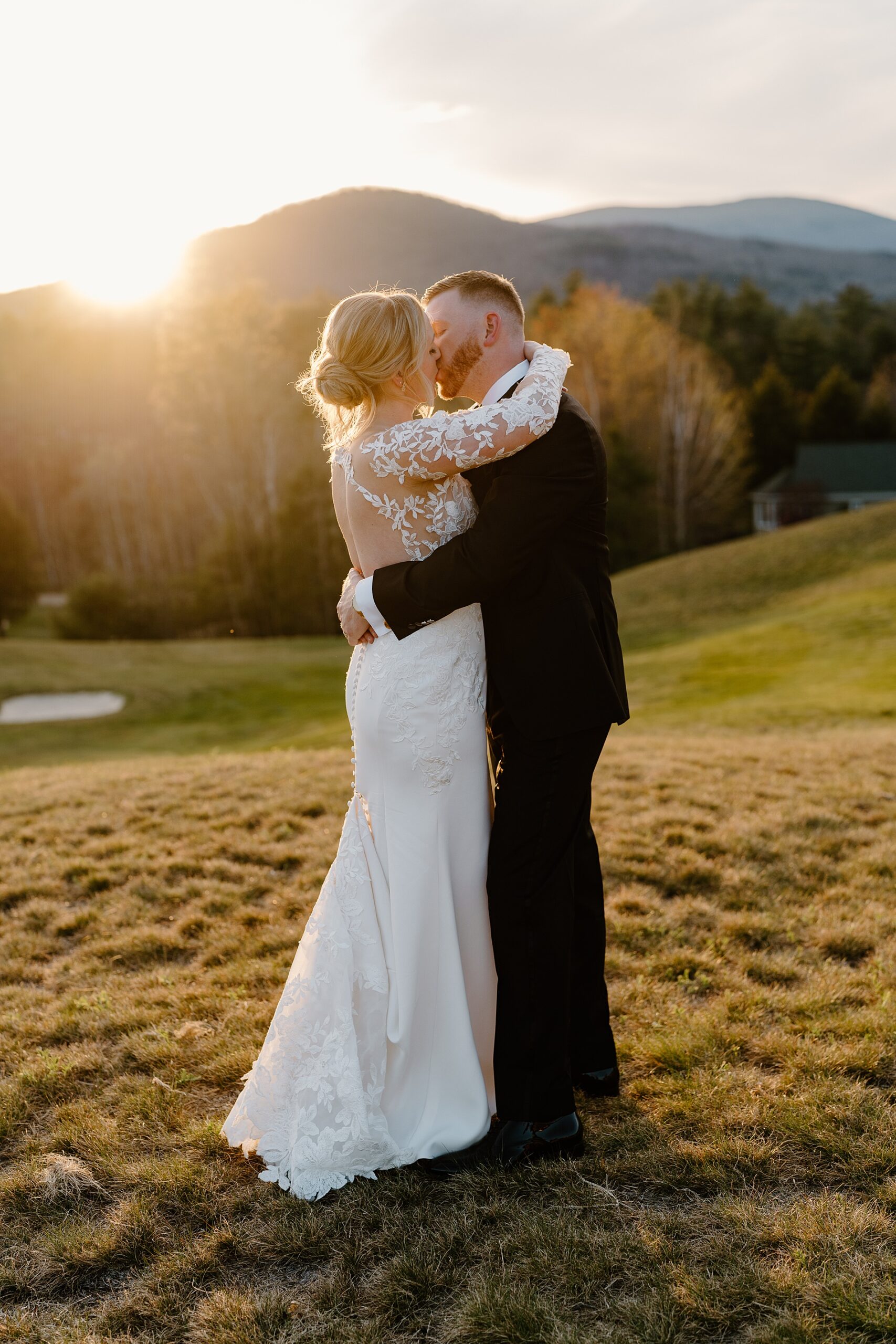 bride and groom kiss during sunset photos