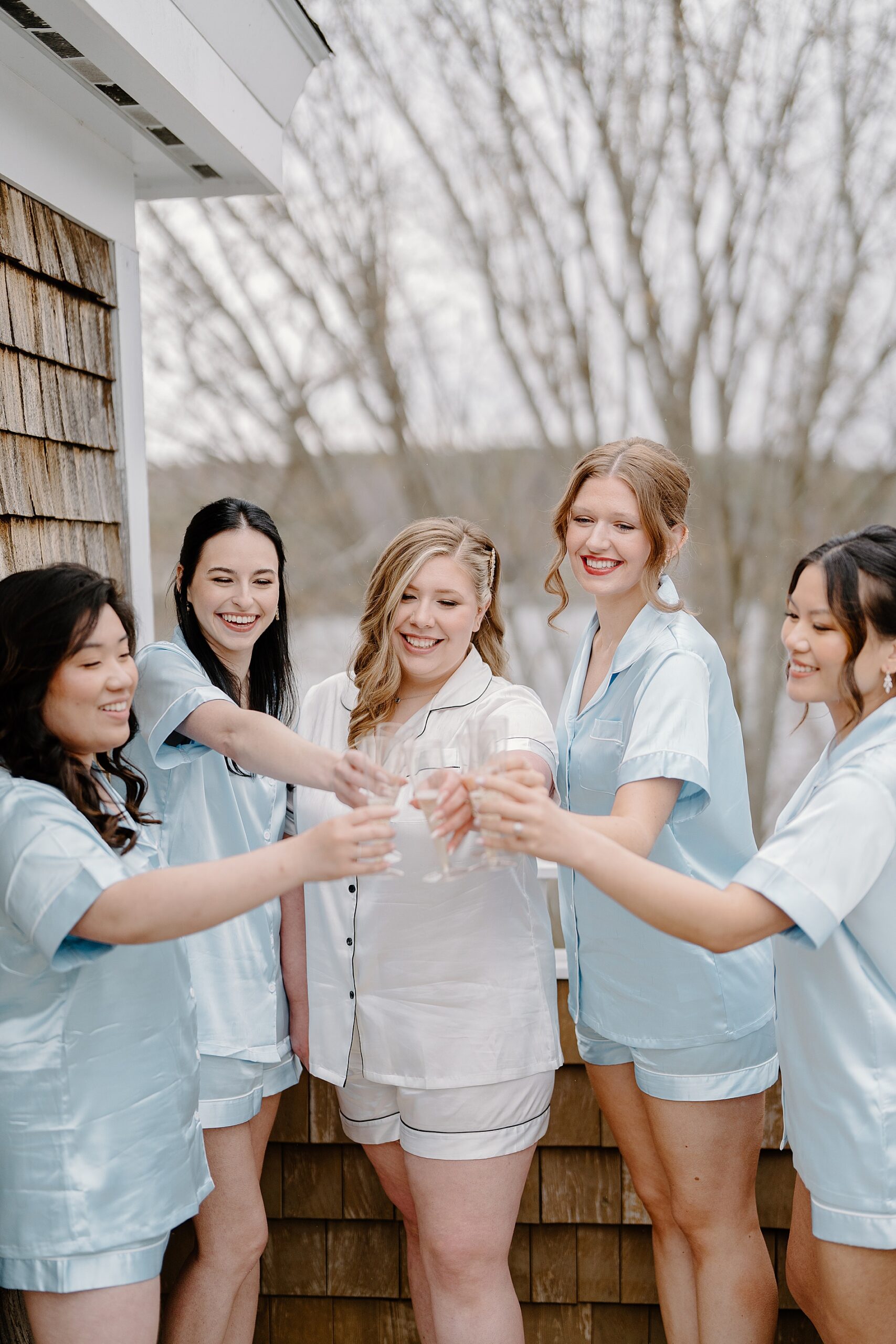 bride and bridesmaids toast while getting ready