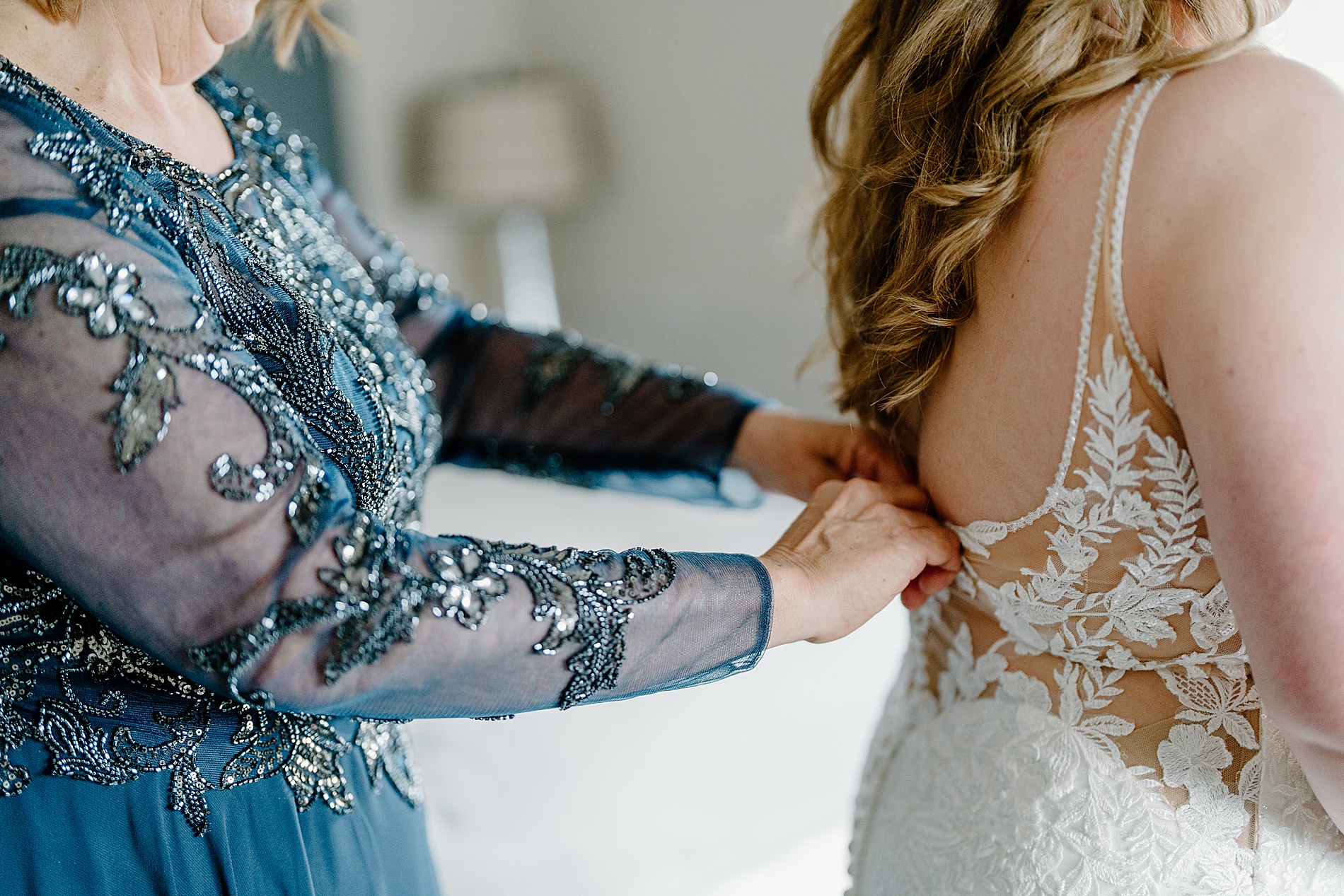 bride getting into wedding dress