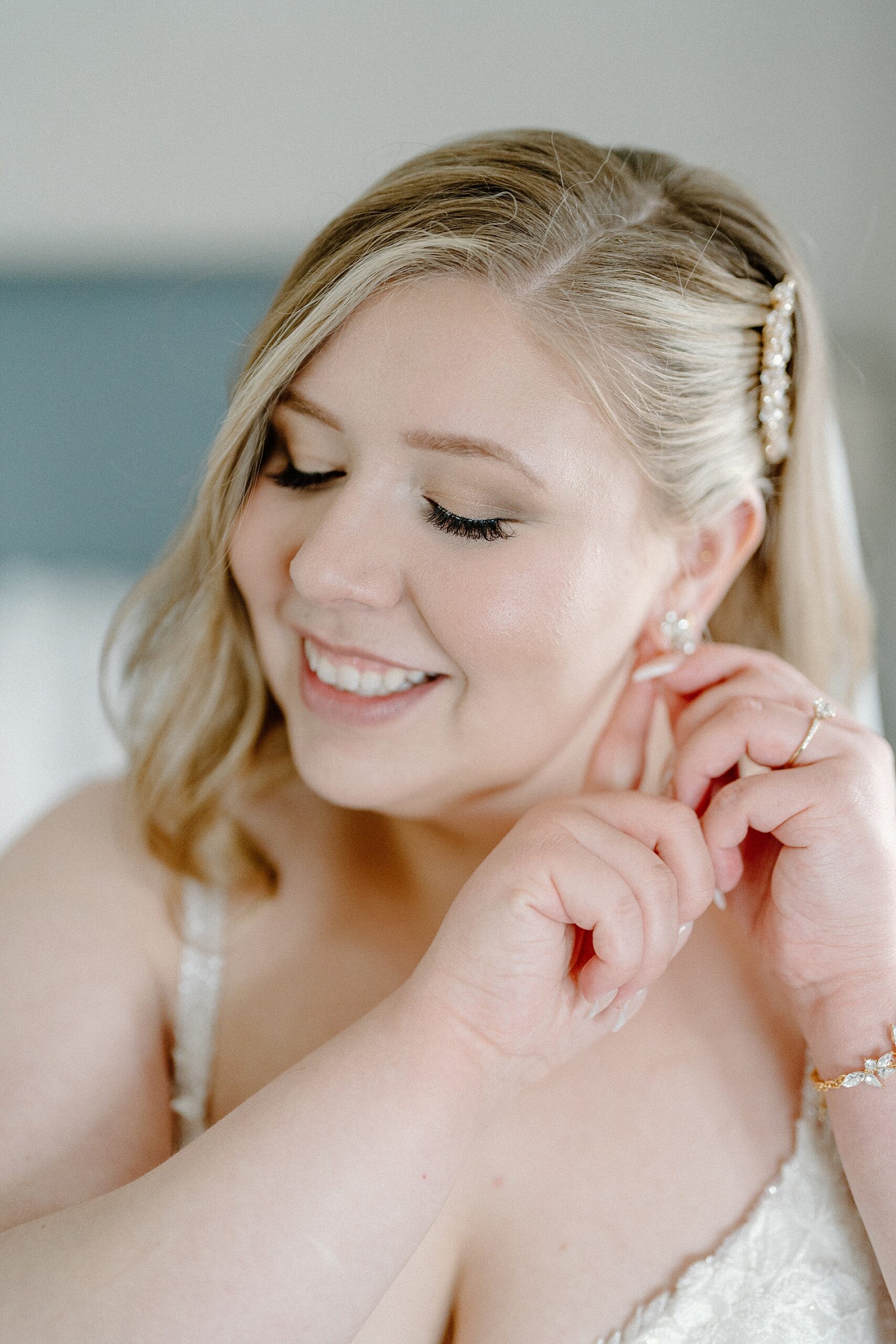bride putting in earrings 