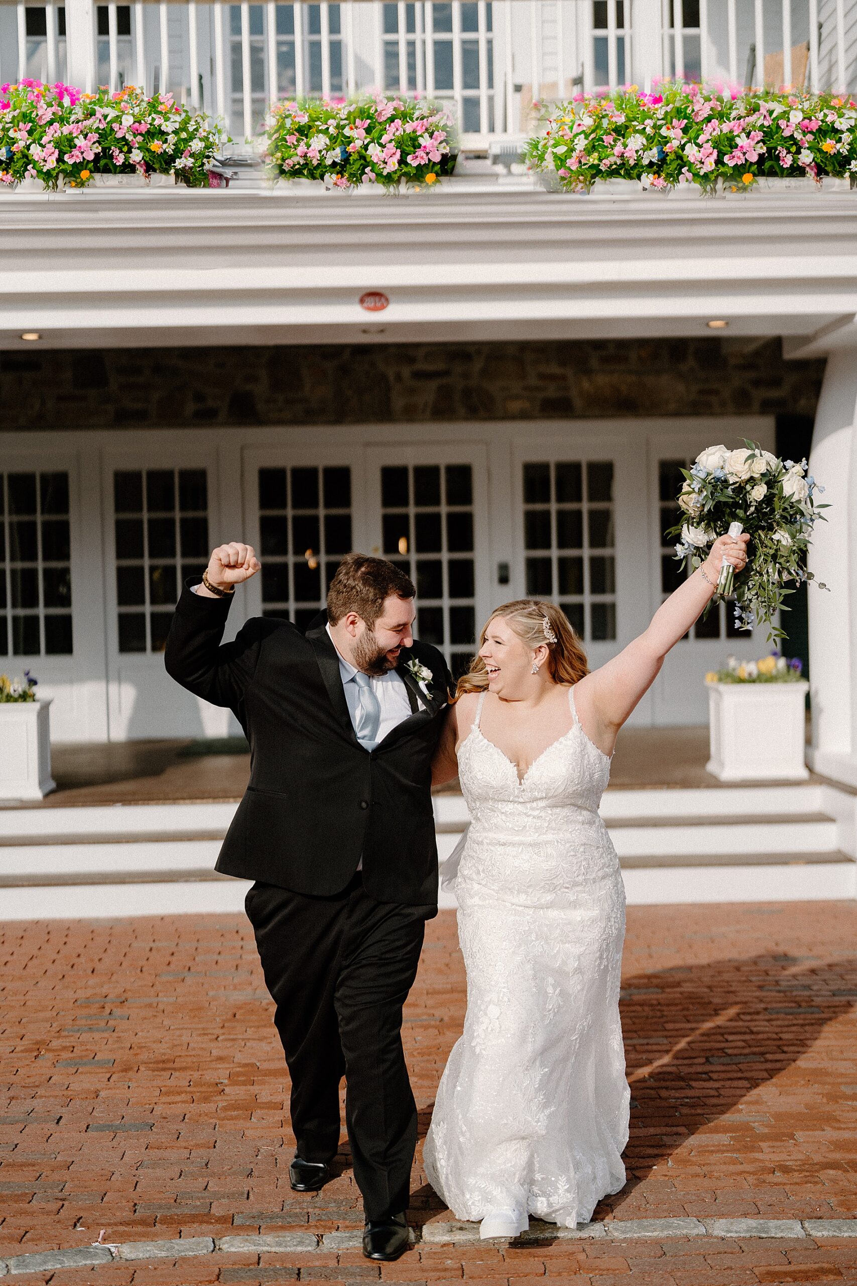 newlyweds outside of lake winnipesaukee wedding venue at Church Landing 