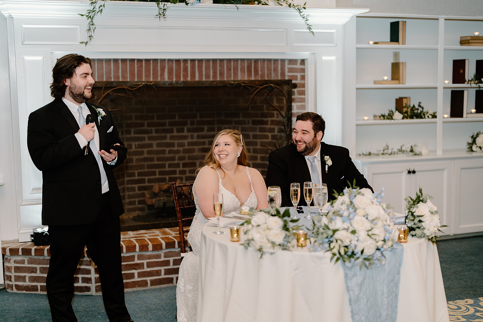 newlyweds listen to wedding toasts