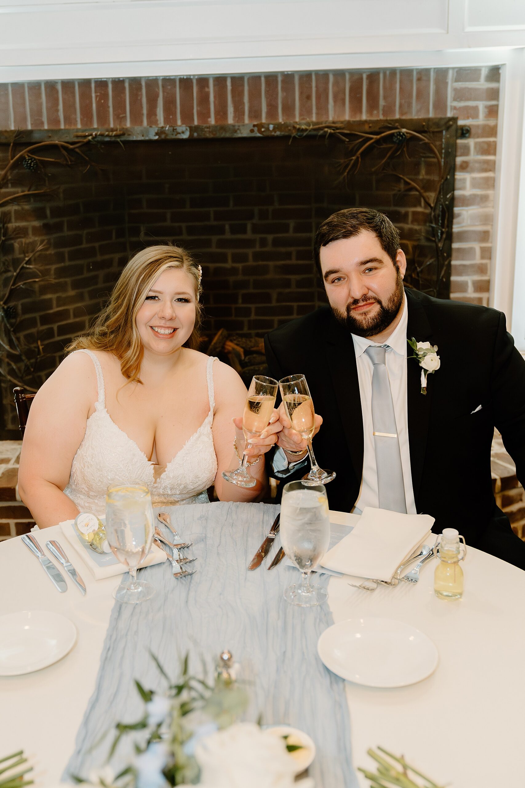 bride and groom toast their glasses 